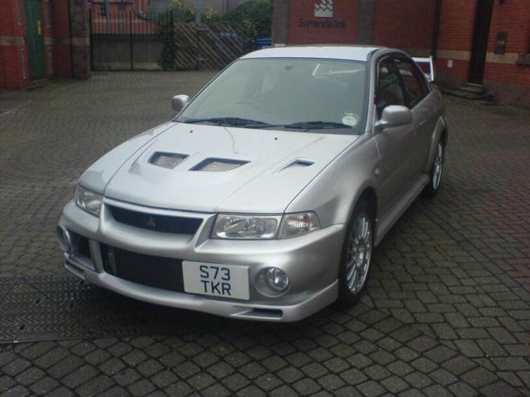 A blue sports car parked in a lot

AI-generated content may be incorrect.