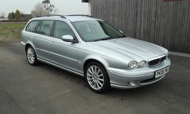 A red car parked on a road

AI-generated content may be incorrect.