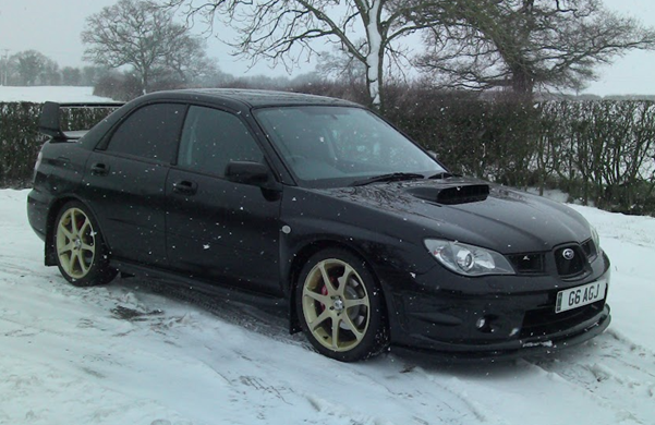 A black car parked in the snow
AI-generated content may be incorrect.