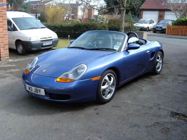 A blue sports car parked in a lot
AI-generated content may be incorrect.