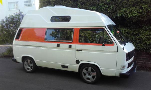 A white and orange camper van
AI-generated content may be incorrect.